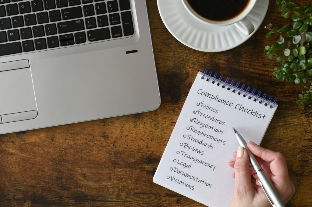 Female checking off items on Compliance checklist in the workplace