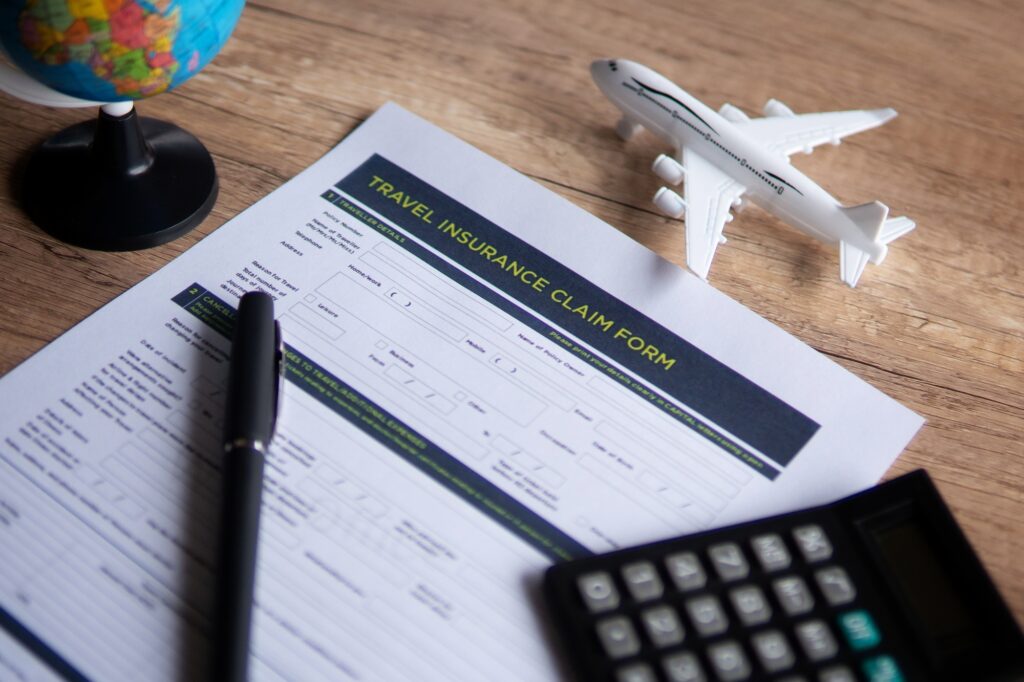 Selective focus image of travel insurance claim form on a wooden table.
